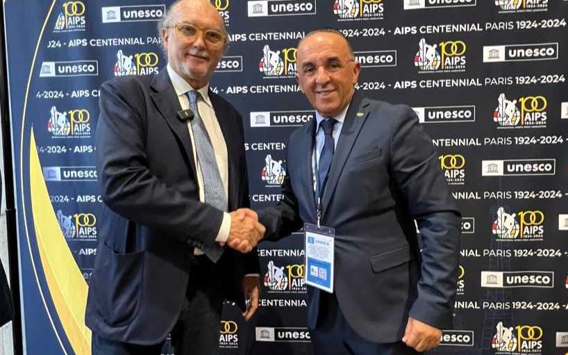 Le président de l'AIPS, Gianni Merlo, et le membre du CE de l'AIPS, Morad Moutaouakkil, du Maroc, se serrent la main après l'annonce de Maroc 2025 au siège de l'UNESCO à Paris..